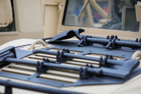 Tools mounted on the hood of a Humvee military vehicle - hammer, axe, shovel and pickaxe