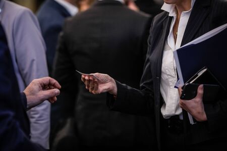 Details with the hand of a business woman receiving a business card