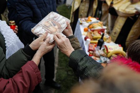 Shallow depth of field (selective focus) image with the hands of people holding sweets during a...