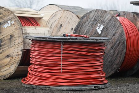 Wooden cable reels outdoors during a cold rainy day.の写真素材
