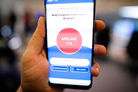 Bucharest, Romania - February 11, 2020: Shallow depth of field (selective focus) image with Romanian  112 emergency number mobile app (Romanian version of 911).のeditorial素材