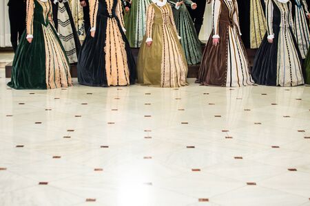 Details with the medieval/Renaissance dresses of women singing in a choir.