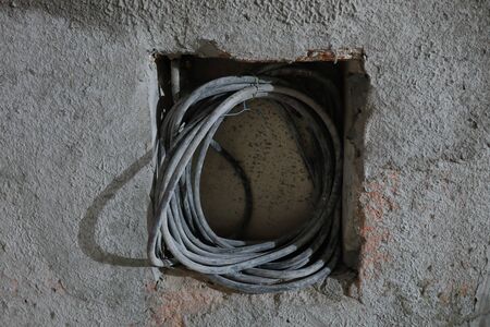 Shallow depth of field (selective focus) image with a wall and electricity cables in an unfinished building on a hospital construction site.の写真素材
