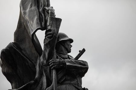 Bucharest, Romania - February 21, 2020: Soviet soldier statue at the Red Army Cemetery in Bucharest during a cold and rainy winter day.のeditorial素材