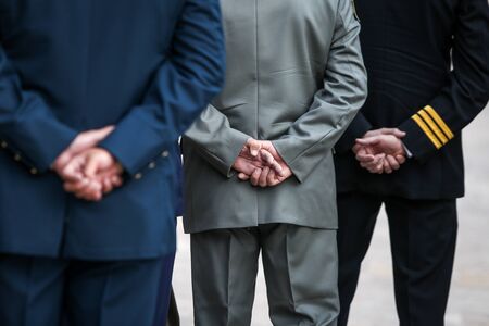Details with Romanian army veterans holding their hands at their backs.