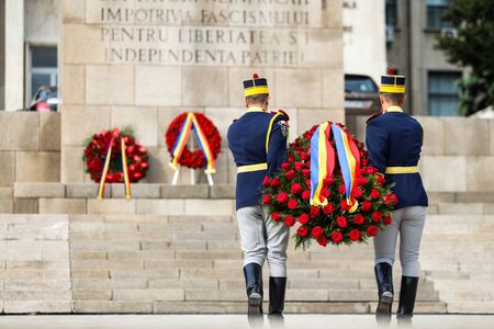 Bucharest, Romania - May 9, 2019: Michael the Brave 30th Guards Brigade soldiers lay funeral wreaths during a ceremony at the Military Academy and Monument of Country Heroes.のeditorial素材