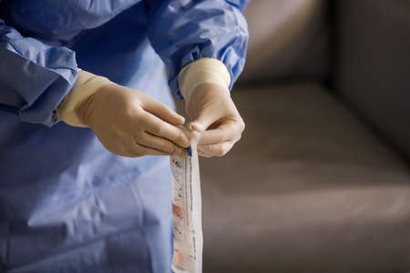Bucharest, Romania - March 13, 2020: Details with the hands of a medic using a coronavirus test on a...