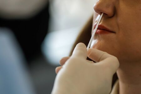 Bucharest, Romania - March 13, 2020: Details with the hands of a medic using a coronavirus test on a...