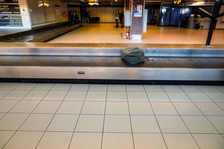 Otopeni, Romania - February 25, 2020: Cardboard box luggage on the baggage carousel in an international airport.のeditorial素材