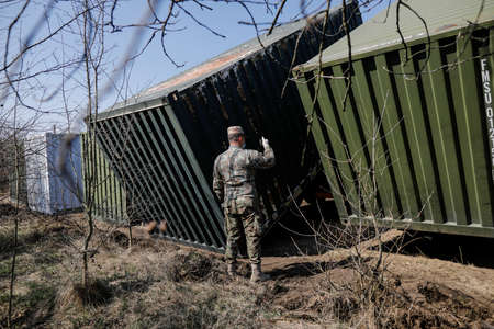 Otopeni, Romania - February 19, 2020: Personnel of the Romanian Army work on the installation of a campaign mobile hospital (ROL 2) to treat Covid-19 patients.のeditorial素材
