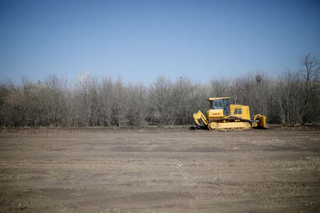 Otopeni, Romania - February 19, 2020: Heavy machinery of the Romanian Army level the ground for a...