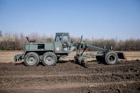 Otopeni, Romania - February 19, 2020: Heavy machinery of the Romanian Army level the ground for a...