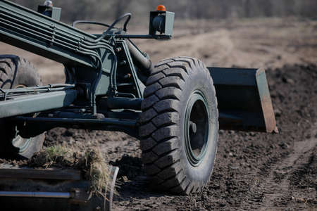 Otopeni, Romania - February 19, 2020: Heavy machinery of the Romanian Army level the ground for a...