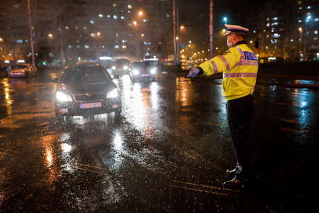 Bucharest, Romania - March 23, 2020: Police check out drivers and their papers during the curfew in the streets of Bucharest amid the spread of the COVID-19.のeditorial素材