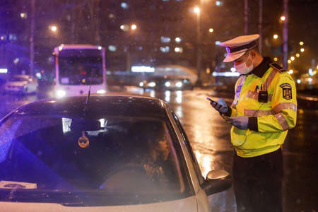 Bucharest, Romania - March 23, 2020: Police check out drivers and their papers during the curfew in the streets of Bucharest amid the spread of the COVID-19.のeditorial素材