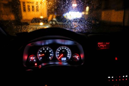 Shallow depth of field image (selective focus) with the steering wheel and dashboard lights of a...