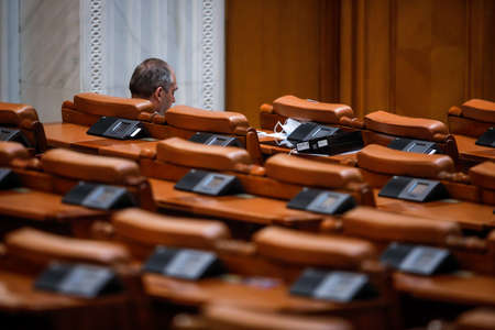 Bucharest, Romania - April 23, 2020: Empty seats and very few MPs in a Romanian Parliamentâ€™s...
