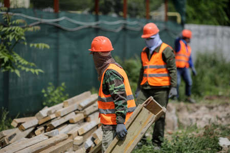 Bucharest, Romania - May 14, 2020: Asian construction workers on a construction site in Bucharest.のeditorial素材