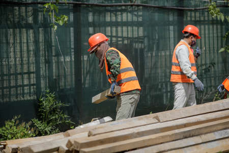 Bucharest, Romania - May 14, 2020: Asian construction workers on a construction site in Bucharest.のeditorial素材