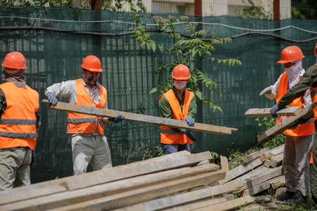 Bucharest, Romania - May 14, 2020: Asian construction workers on a construction site in Bucharest.のeditorial素材