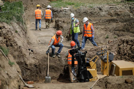 Bucharest, Romania - May 14, 2020: Asian construction workers on a construction site in Bucharest.のeditorial素材