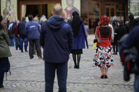 Bucharest, Romania - May 28, 2020: People attend an Orthodox Church service outside the Patriarchal Palace with social distancing during the covid-19 outbreak.のeditorial素材