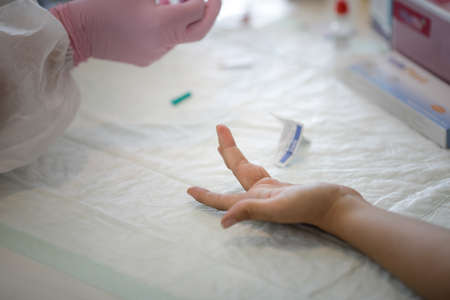 Bucharest, Romania - June 10, 2020: Details with a health official taking a fast Covid-19 Antibody Test (past infection).のeditorial素材