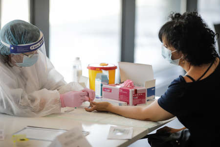 Bucharest, Romania - June 10, 2020: Details with a health official taking a fast Covid-19 Antibody...