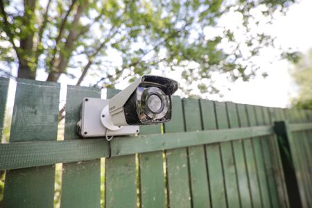Shallow depth of field (selective focus) image with an unused and cover in spider webs cctv camera.