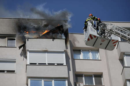 Bucharest, Romania - August 6, 2020: Firefighters try to extinguish a fire that spread across an apartment in a block of flats.のeditorial素材