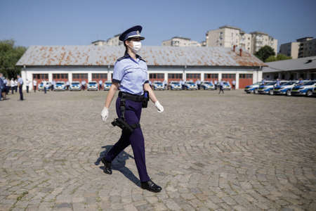 Bucharest, Romania - July 29, 2020: Romanian Police female officer wearing mask during an event of...