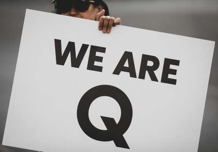 Bucharest, Romania - August 10, 2020: People display Qanon messages on cardboards during a political rally.のeditorial素材
