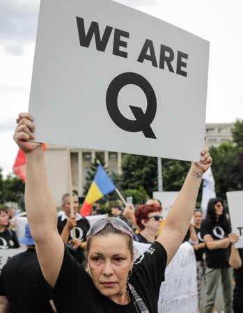 Bucharest, Romania - August 10, 2020: People display Qanon messages on cardboards during a political rally.のeditorial素材