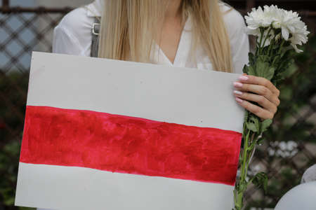 Bucharest, Romania - August 16, 2020: Details with people holding banners and flowers during a political rally supporting the protests in Belarus.のeditorial素材