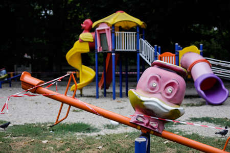 Bucharest, Romania - August 20, 2020: Toys from a playground in a park are being off limits due to the Covid-19 outbreak.のeditorial素材