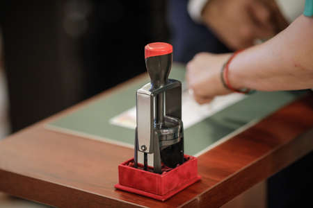 Official stamper on a wooden table
