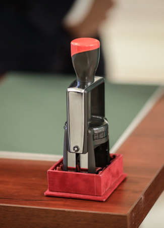 Official stamper on a wooden table