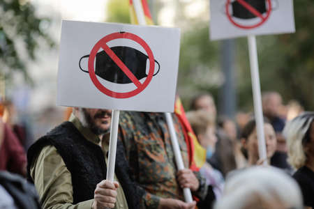 Bucharest, Romania - October 10, 2020: People display anti face masks wearing banners during a political rally.のeditorial素材