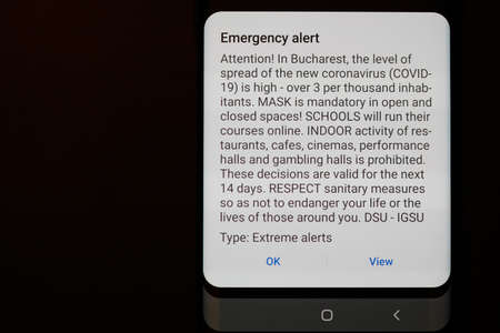 Bucharest, Romania - October 20, 2020: Details with a RO ALERT message received by all the inhabitants of Bucharest regarding the spread of the Covid-19 virus and new restrictions.のeditorial素材