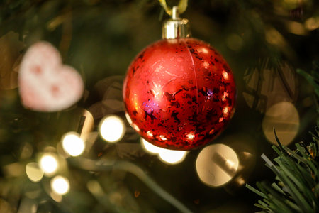 Shallow depth of field (selective focus) image with a red ornament in a plastic Christmas tree.の写真素材