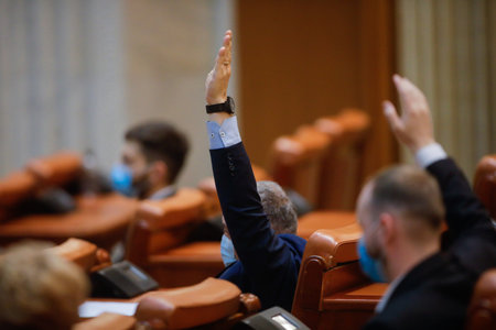 Bucharest, Romania - December 22, 2020: Romanian deputies vote bills by raising their hands in a full Chamber of Deputies meeting.のeditorial素材