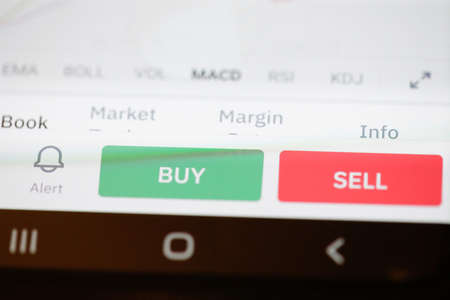 Bucharest, Romania - March 16, 2021: Details with the Sell and Buy buttons on a Bitcoin cryptocurrency exchange app.のeditorial素材