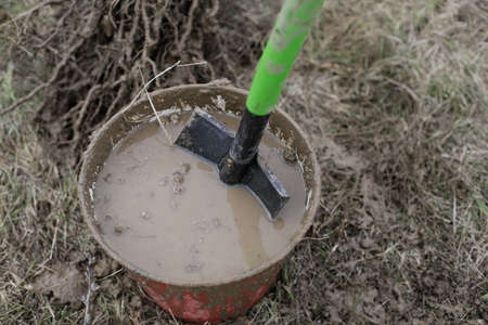 Shallow depth of field (selective focus) details of a dirty shovel during a tree plantation.の写真素材