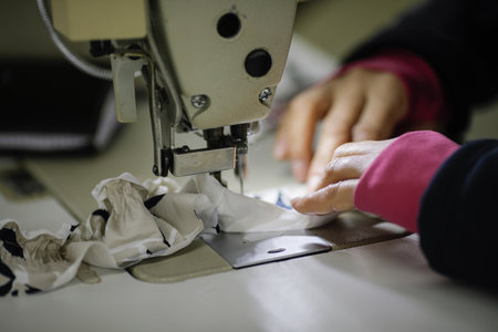 Shallow depth of field (selective focus) image with the hands of a senior woman working at an...