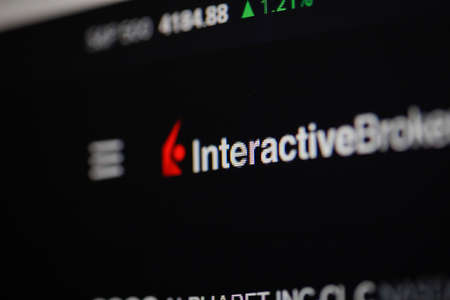 Bucharest, Romania - April 24, 2021: Shallow depth of field (selective focus) and macro image with Interactive Brokers app on a digital screen.のeditorial素材