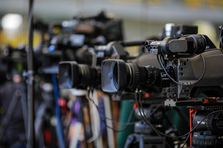Bucharest, Romania - April 25, 2021: Shallow depth of field (selective focus) image with TV cameras on tripods on a press event.のeditorial素材