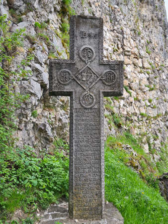 Bran, Romania - May 16, 2021: Medieval stone cross at the Bran Castle, known also as Draculaâs Castle in Transylvania, Romania.のeditorial素材