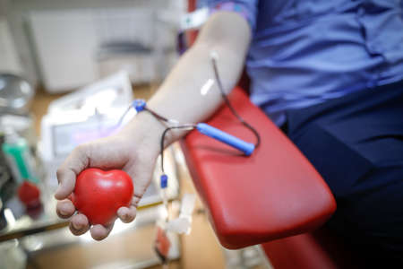 Shallow depth of field (selective focus) details with the hand of a man donating blood.の写真素材
