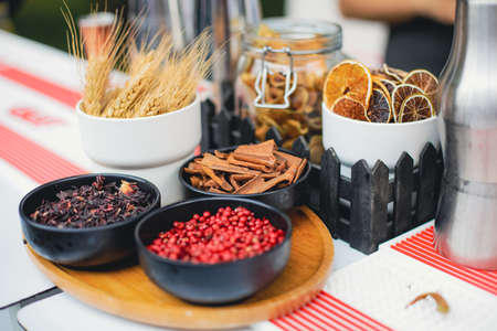 Shallow depth of field (selective focus) image with spices on the counter of a bar during a garden party.の写真素材
