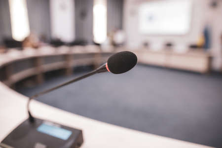 Shallow depth of field (selective focus) image with a microphone in a conference room.